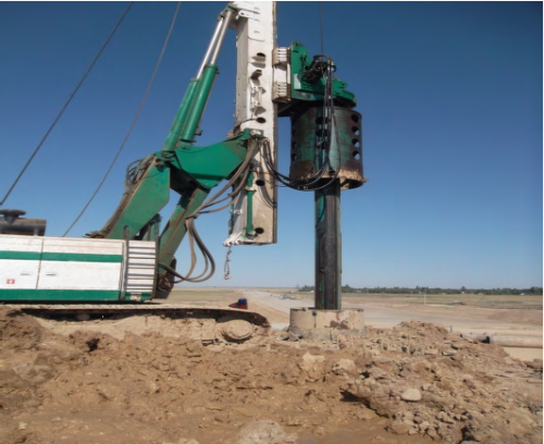 Well drilling under driven pile on interchange